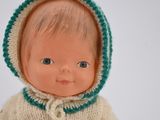 a doll that is wearing a sweater with a hood on