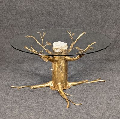 an image of a glass table with a gold tree on it