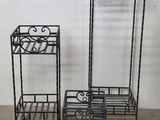 three black metal plant stands sitting on top of a wooden floor