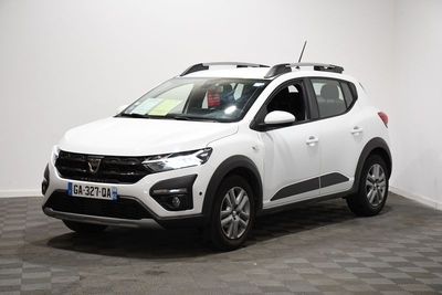 a white car is parked in a room with a checkered floor