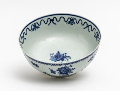 a blue and white bowl sitting on a white surface