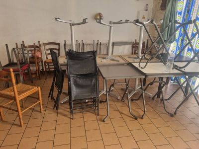 many chairs and tables in a room with a window