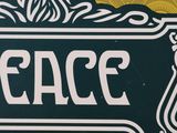 a sign that says peace with a tree on it