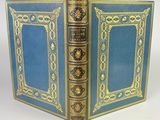 an old blue book with gold trimming and a gold trimming