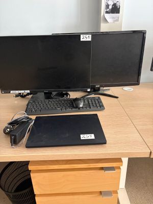 a desk with a laptop, monitor, keyboard and mouse on it