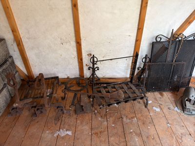 a lot of old metal items on the floor of this room