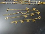 several different types of necklaces and bracelets on a table