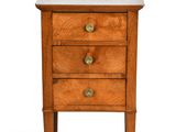 a small wooden table with three drawers and a marble top