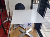 a table with a number 30 on it in front of a window