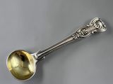 a close up of a spoon with a handle on a table