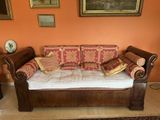 a couch that is sitting in a room with orange walls