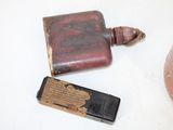 an old flask and a lighter on a table