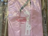 a pink shirt with a giraffe on it wrapped in plastic