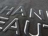 a close up of a black shirt with white writing on it