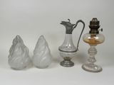 three glass vases and a glass lamp on a white surface