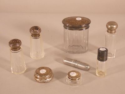 a lot of small glass bottles with silver caps on them
