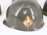 three helmets with stickers on them sitting next to each other