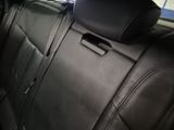 a black car with a black seat belt in the back of it