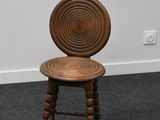an image of a wooden chair with a circular back rest