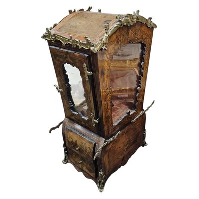 a small wooden clock with a mirror on top of it