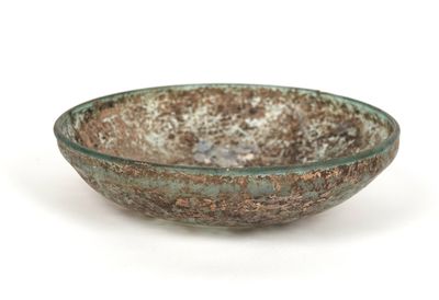 a glass bowl that is sitting on a white surface