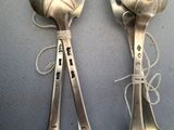 two spoons that are tied together on a table