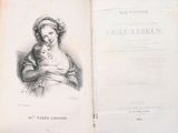 an old book with a picture of a woman holding a baby