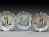 trois petites assiettes ornées de personnages peints, disposées les unes à côté des autres