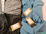three pairs of jackets with tags on them sitting next to each other