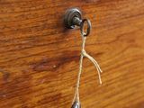 a wooden box with a key hanging from it ' s handle