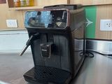 a black coffee machine sitting on a counter in a kitchen
