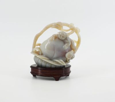 chinese carved ivory figurine of a baby in a basket on a stand