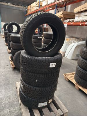 tires are stacked on pallets in a warehouse with pallets of pallets