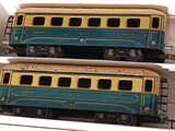 two blue and yellow train cars in a white box