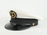 black and white captain ' s hat with gold emblem on top