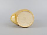 a close up of a gold ring on a white surface