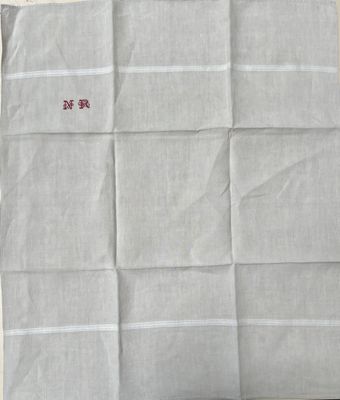an image of a piece of white linen with a red stitching on it