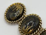 an image of a close up of a bracelet with two oval beads