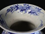 a blue and white vase with blue flowers on it