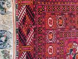 an image of a red and black rug on a white floor