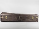a brown suitcase sitting on a white surface