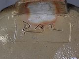 a close up of a vase with a tag on it