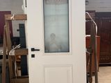 une porte blanche avec une vitre dans une pièce