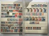 two pages of stamps on display on the wall