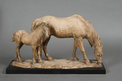a statue of a horse and a baby horse on a table