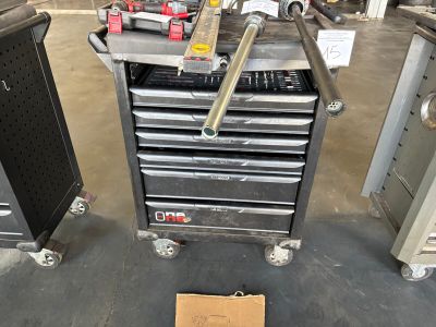 a tool cart with tools on top of it in a garage