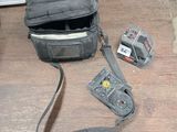 a bag that is sitting on the floor next to a camera