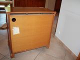 a small wooden cabinet with a door on it