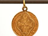 a close up of a gold coin hanging on a string
