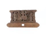 an old wooden sculpture of a group of people sitting on a bench